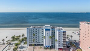 A beachfront hotel with multiple floors, a pool area, and a view of the ocean. - Gulf-Front Condo | Heated Pool, Beach Access & Walk to Times Square (Fort Myers Beach)