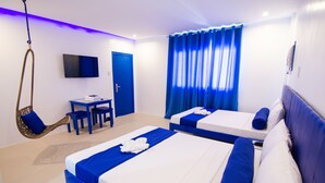 A hotel room with two beds, a desk, a chair, and a television. - Skytel Palawan (Puerto Princesa)