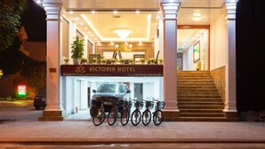 The exterior of Victoria Hotel with a sign, a staircase, and bicycles parked in front. - Victoria Hotel Ninh Binh (Hoa Lu)