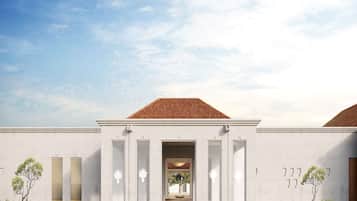 A modern building with a flat roof, large windows, and a symmetrical facade.