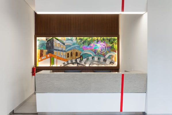 A modern interior with a view of a colorful mural, a wooden ceiling, and a red stripe on the wall.