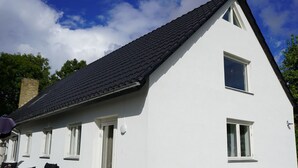 A white house with a dark roof, two windows, and a chimney. - Stay Home Villa (Rødovre)