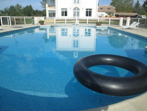 Seasonal outdoor pool, a heated pool, pool umbrellas, pool loungers