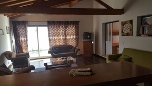 A living room with a sofa, a coffee table, and a television. - Quinta do Valão (Alcobaça)