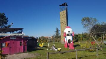 A playground with a slide, swings, and a climbing structure.