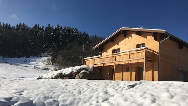 A wooden cabin with a balcony, surrounded by snow-covered ground and trees. - the shepherd's chalet. (Ventron)
