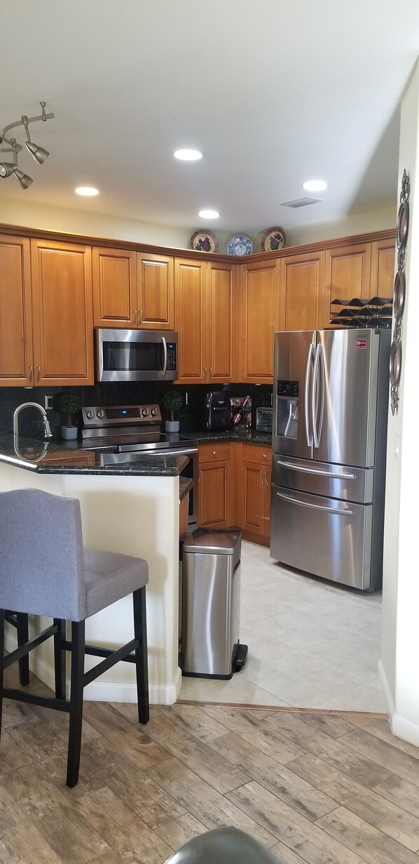 Fridge, microwave, stovetop, dining tables