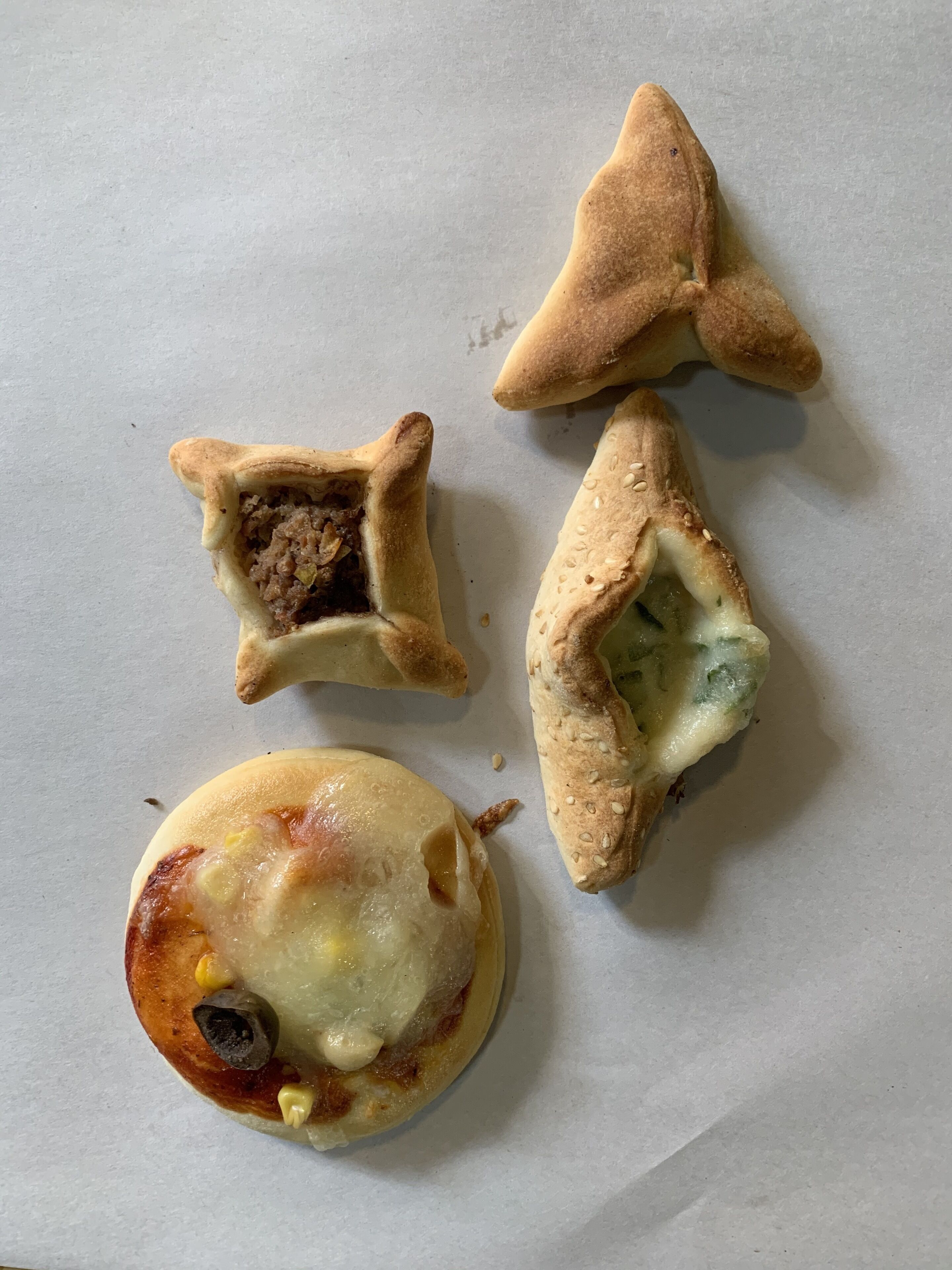 Four pastries on a white surface.