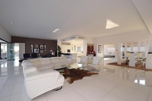 Basic Penthouse, 4 Bedrooms | Living area | 52-inch Smart TV with digital channels, TV, video-game console