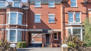 A red brick building with bay windows and a central entrance. - West Bridgford Classy 2bed Flat (Nottingham)