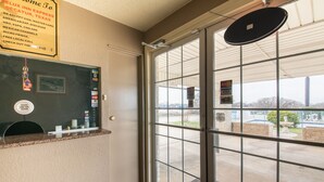 A hotel reception area with a glass door leading outside. - OYO Hotel Decatur TX Hwy 287 Northwest (Decatur)