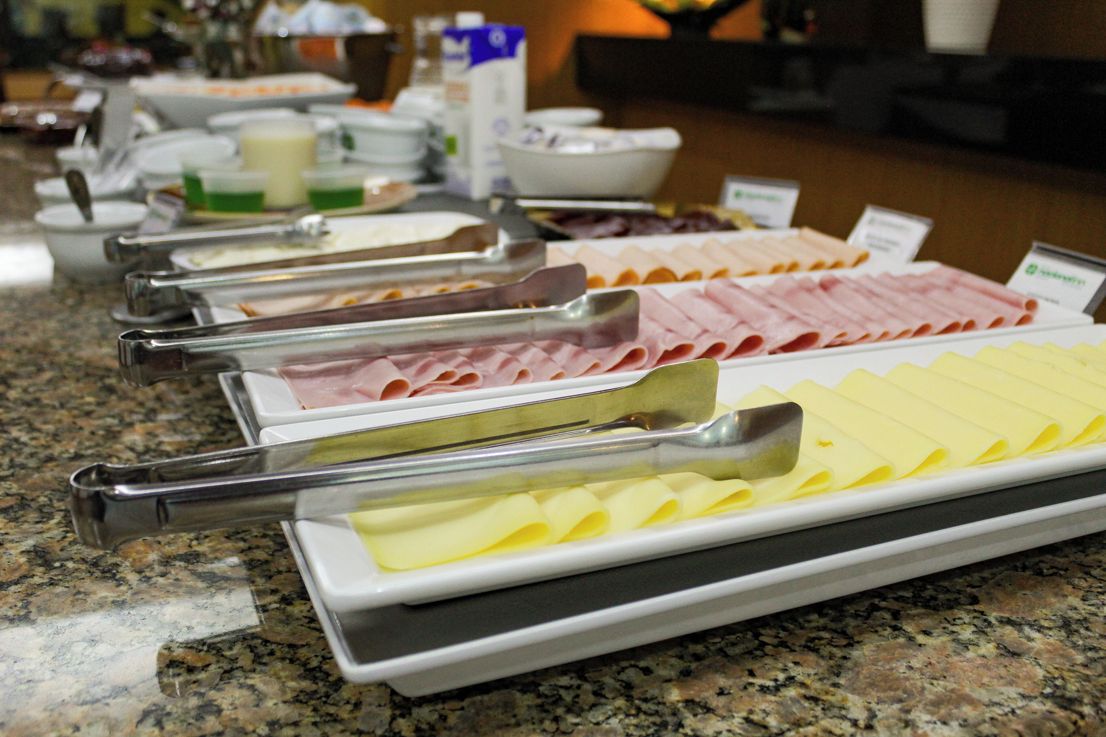 A buffet with various food items and serving utensils.