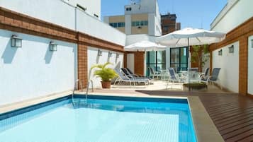 Outdoor pool, open 7:00 AM to 10:00 PM, pool umbrellas, pool loungers