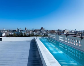 A rooftop swimming pool with a cityscape view. - Raval House (Barcelona)
