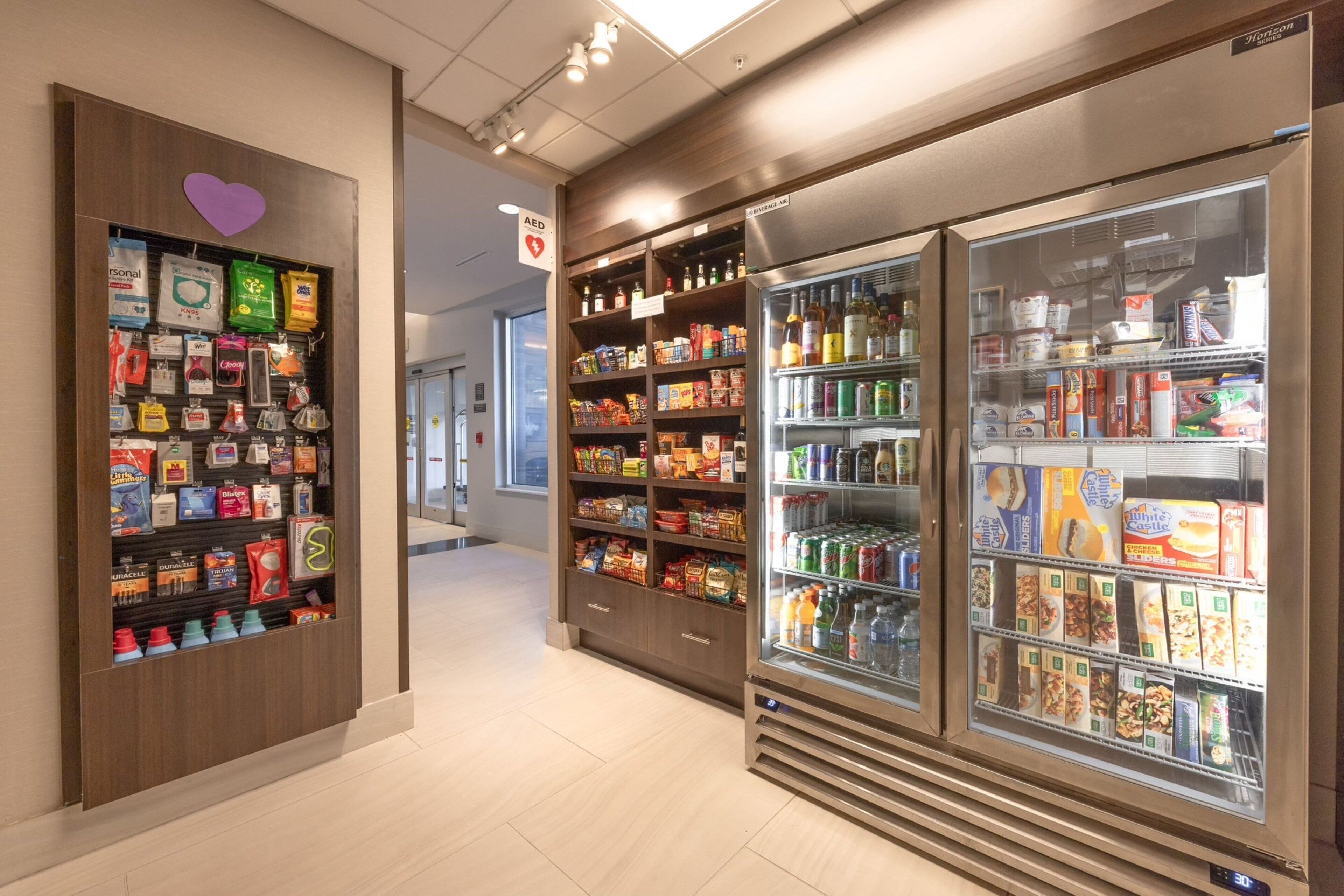 A pharmacy with shelves stocked with various health and wellness products, including personal care items and beverages.