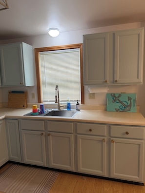 A kitchen with a window, sink, cabinets, and a wooden countertop. - Perfect Family Escape! Walk to everything and relax. It’s all here for you  (York)