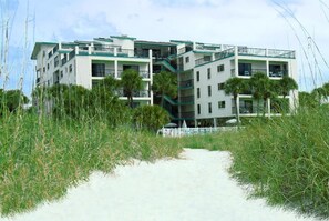 Stunning hotel with modern architecture, surrounded by lush greenery and palm trees.