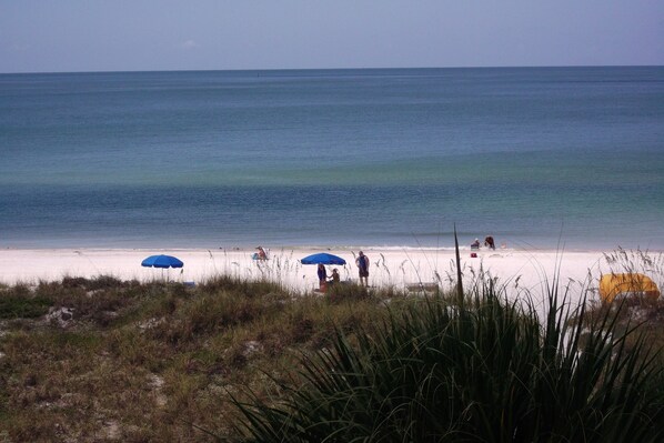 Enjoy the serene ocean views and relax under the shade of two beach umbrellas.