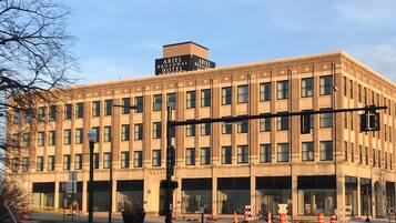A large, multi-story building with a prominent sign reading "Ariel Broadway Hotel."