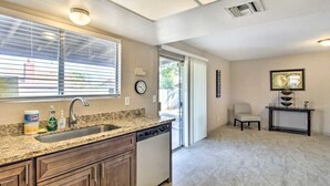 A kitchen with a granite countertop, a dishwasher, and a window with blinds. - Near Starr Pass-Downtown- U of A  3 Bedoom Home (Tucson)