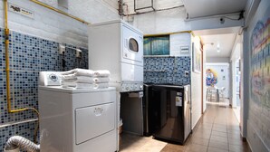 A laundry area with a washing machine, dryer, and a refrigerator. - Magdalen House (Lima)