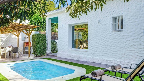 A white building with a pool, outdoor seating, and a pergola. - Villa Conchita Torremolinos (Torremolinos)