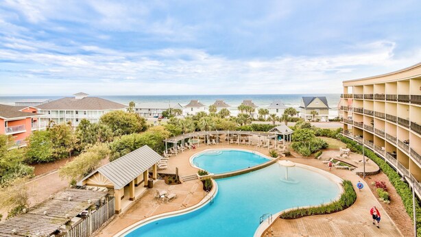 A resort with a large pool, multiple buildings, and a view of the ocean. - 5th floor, Gulf views, 2 Pools, Free Beach Service, Garage Parking (Miramar Beach)