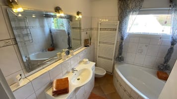 Bathtub, hair dryer, bidet, towels