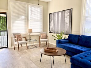 Relax in this inviting living space with a comfortable sofa, armchairs, and a coffee table.