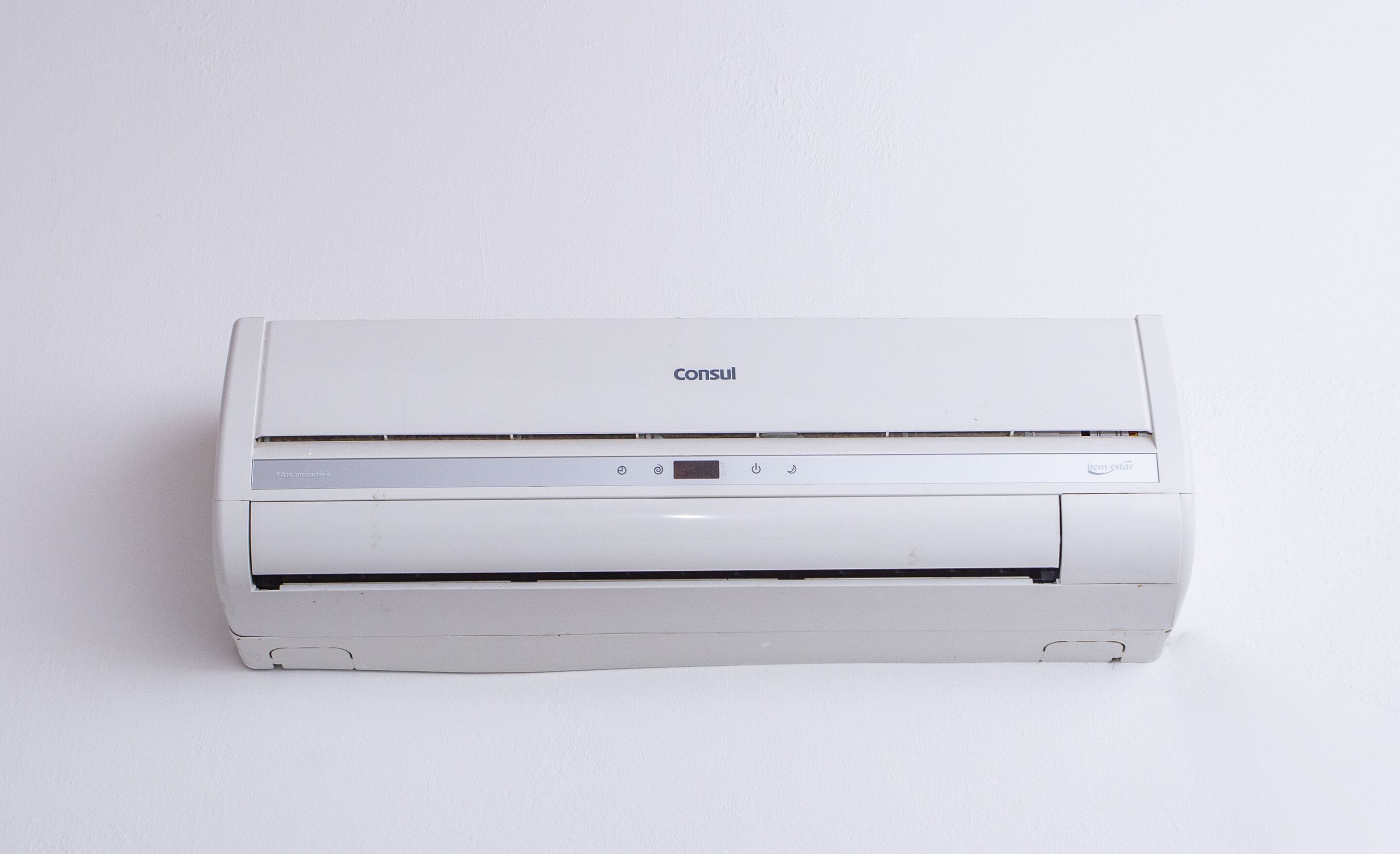 A white Consul air conditioner unit with a control panel and a front paper output slot.