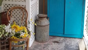 A rustic interior with a blue cabinet, a wicker chair with a vase of flowers, and a sign reading "FARMHOUSE". - AZ Ranch House, near UofA & Banner Hosp /midtown (Tucson)