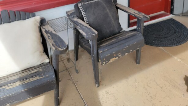 A porch with two worn-out chairs and a red door. - AZ Ranch House, near UofA & Banner Hosp /midtown (Tucson)