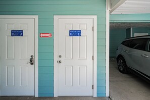 Two doors labeled 'Beach Closet Unit A' and 'Unit B' with a fire exit sign above them. - 1 Step to the Beach! Beachfront Condo with 3 Sunset Decks, Sleeps 6 (Indian Rocks Beach)