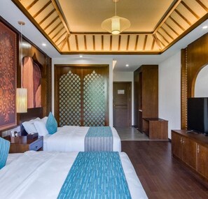 A hotel room with two beds, a TV, and a wooden ceiling. - Floral Hotel · River Rhythms Pavilion Jinghong (Xishuangbanna Dai)