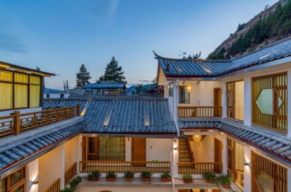 A traditional courtyard with tiled roofs and wooden railings.