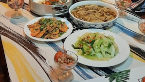 A dining table with various dishes, a teapot, and a decorative plate with cacti illustrations. - Nasun bed and breakfast (Jianshi)