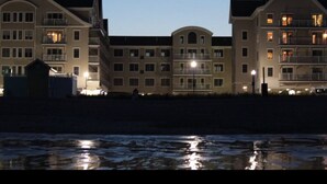 A multi-story hotel with a symmetrical facade, large windows, and balconies.