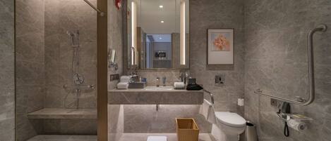 Un baño moderno con ducha a nivel, inodoro y bidé.