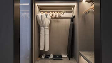 A modern bathroom with a built-in shower, a robe rack, and a towel rack.