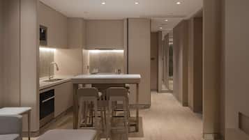 A modern kitchen with a central island, bar stools, and built-in appliances.
