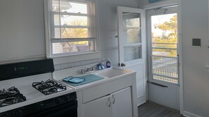 A kitchen with a gas stove, a sink, and a window with blinds. - Beach Block, Renovated 2 bdrm, sleep 6, 2nd Flr unit Parking and 4 beach badges (Seaside Park)