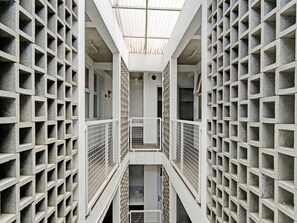 A multi-level concrete structure with a central corridor and staircases. - Hotel O Alamanda 7 Syariah (Bandung)