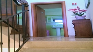 A staircase leading to a bathroom with a sink and a potted plant. - "IL MANDORLO" with swimming pool (FICULLE (TR))