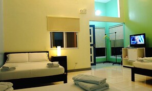 A hotel room with a bed, a TV, a desk, and a bathroom visible through an open door. - Momarco Forest Cove Resort And Hotel (Tanay)