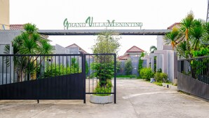 A gated entrance to Grand Villa Meninting with a sign above. - OYO 2284 Grand Villa Meninting (Senggigi)
