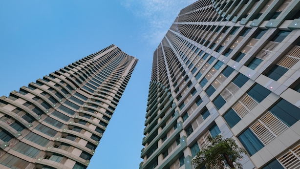 Two high-rise buildings with a clear sky. - OYO 2245 Apartment Grand Kamala Lagoon (Bekasi)