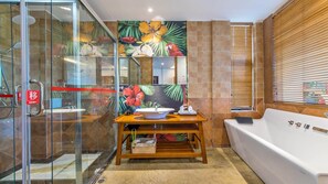 Un baño moderno con cabina de ducha de vidrio, tocador de madera con lavamanos y bañera blanca.