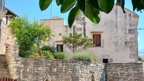 A stone building with a rustic facade, a wooden door, and a small window. - Studio for Couples -Traditional Stone built - Rural location (Kefalas nr Vamos) (Kefalas)