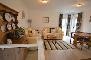 Cozy living space with a sofa set, dining table, and decorative items.