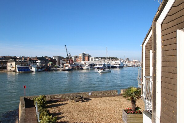 Guests can enjoy stunning waterfront views from the balcony of this marina-side accommodation.